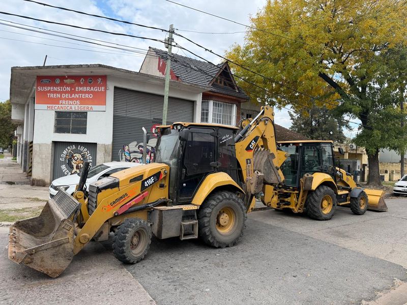 Cuadrilla de operarios con compactador de placa vibradora en planta industrial